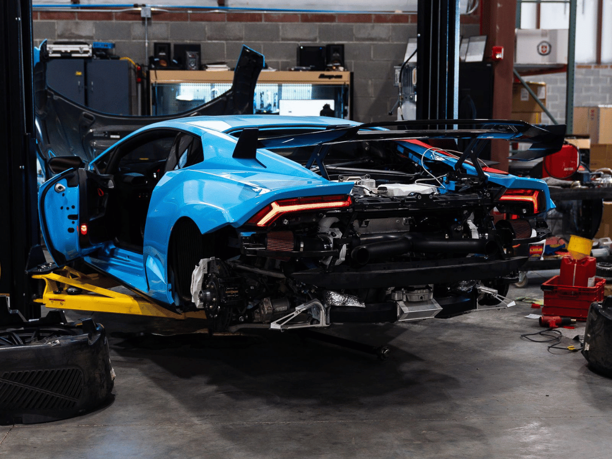 Performance supercar being serviced in a specialty shop